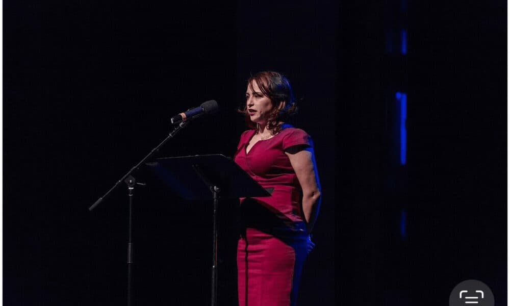Sheila Arias speaking at a podium